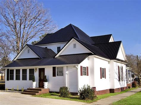 dark metal roof white house|houses with white metal roofs.